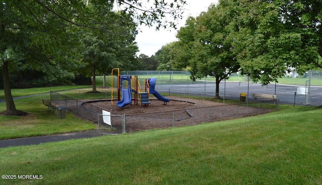 community playground featuring a lawn and fence