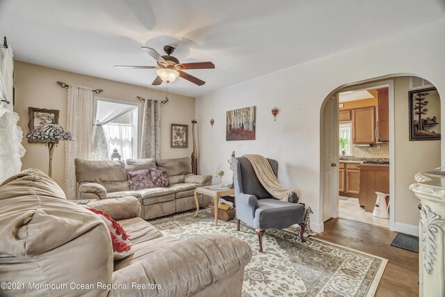 607 Willow St, Lakehurst, NJ 08733 - living area featuring arched walkways, ceiling fan, light wood-type flooring, and baseboards