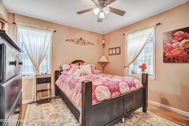 607 Willow St, Lakehurst, NJ 08733 - bedroom featuring multiple windows, wood finished floors, baseboards, and ceiling fan