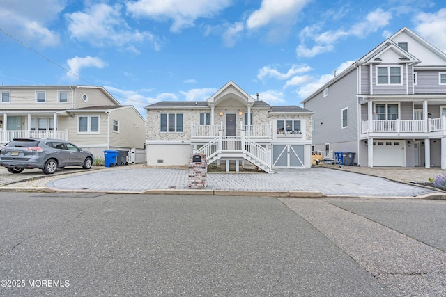 40 Anchorage Dr, Toms River, NJ 08753 - view of front of property featuring stairs, driveway, stone siding, and covered porch