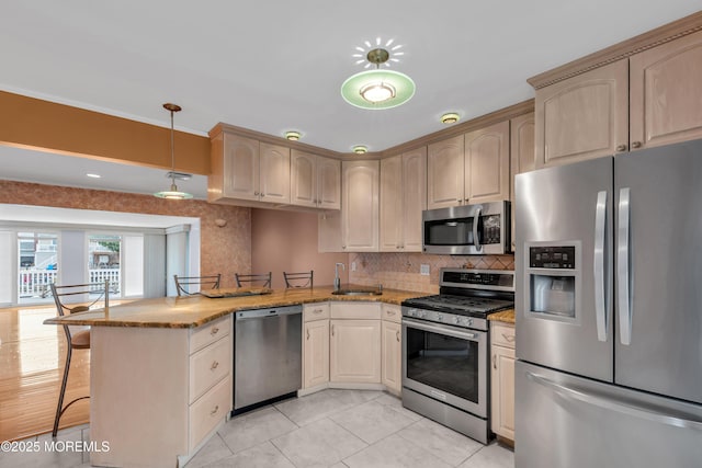 40 Anchorage Dr, Toms River, NJ 08753 - kitchen with appliances with stainless steel finishes, a peninsula, a sink, a kitchen breakfast bar, and tasteful backsplash