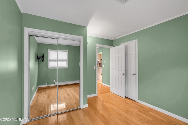 40 Anchorage Dr, Toms River, NJ 08753 - unfurnished bedroom featuring a baseboard radiator, wood finished floors, baseboards, and a closet