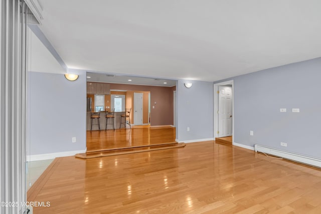 40 Anchorage Dr, Toms River, NJ 08753 - unfurnished living room featuring baseboards, wood finished floors, and baseboard heating
