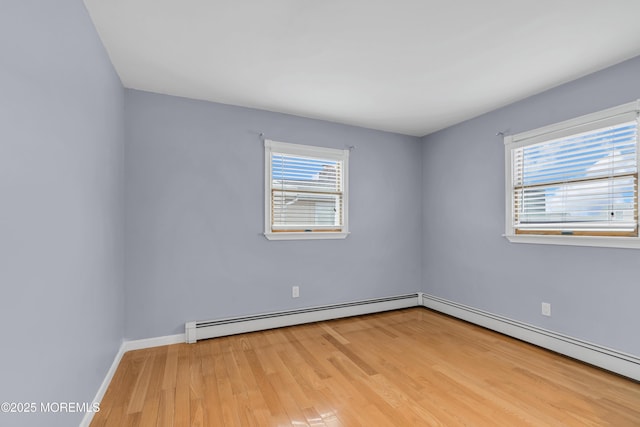 40 Anchorage Dr, Toms River, NJ 08753 - empty room with a baseboard radiator, wood finished floors, and healthy amount of natural light