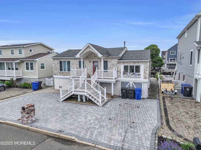 40 Anchorage Dr, Toms River, NJ 08753 - view of front facade with stone siding, stairway, a patio area, and a shingled roof