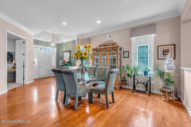 dining space featuring baseboards, light wood-style flooring, a chandelier, ornamental molding, and recessed lighting