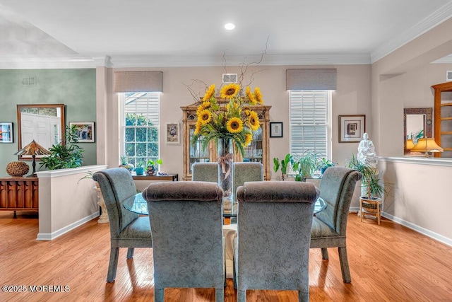 dining space with light wood-type flooring, baseboards, ornamental molding, and recessed lighting
