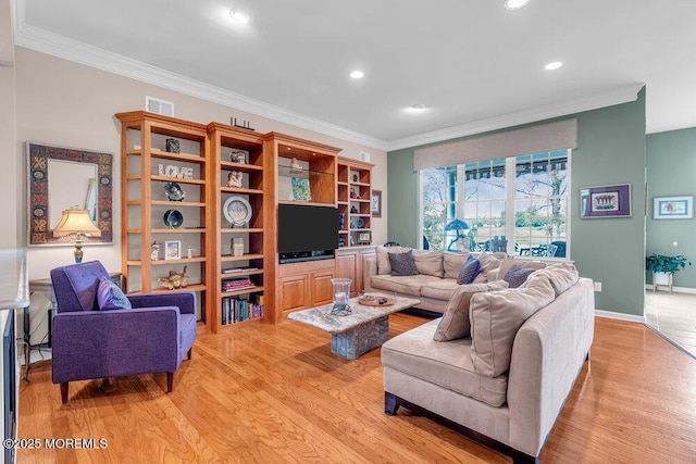 living room featuring light wood finished floors, ornamental molding, recessed lighting, and baseboards