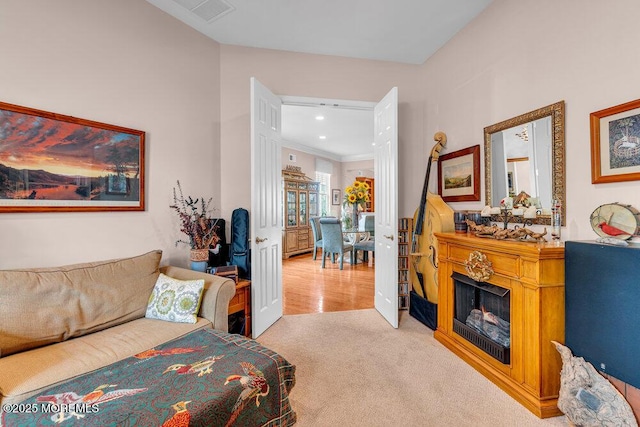 carpeted living room featuring a fireplace