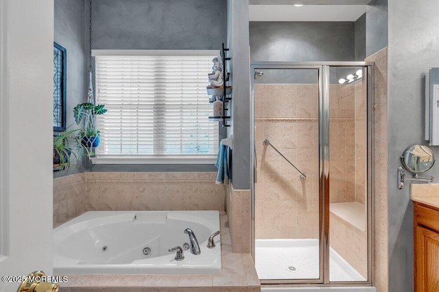 full bathroom featuring a stall shower, a jetted tub, and vanity