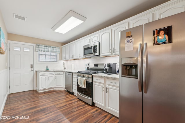 2024 Mount Carmel Blvd, Toms River, NJ 08753 - kitchen featuring dark wood-style flooring, visible vents, white cabinets, and appliances with stainless steel finishes