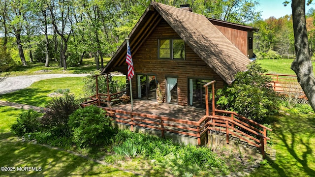 156 Baird Rd, Millstone, NJ 08535 - view of home's exterior featuring a lawn, a chimney, a shingled roof, and a deck