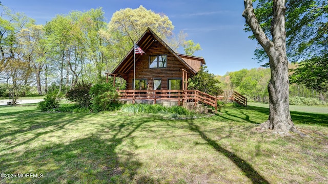 156 Baird Rd, Millstone, NJ 08535 - rear view of house featuring a lawn, log siding, and a deck