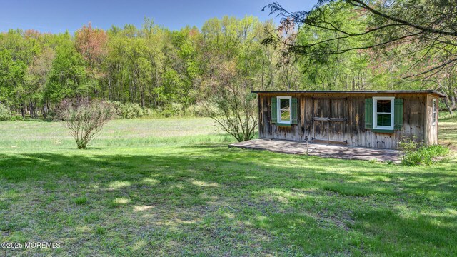 156 Baird Rd, Millstone, NJ 08535 - view of yard featuring an outdoor structure and a wooded view