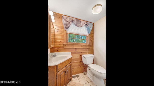 156 Baird Rd, Millstone, NJ 08535 - bathroom with tile patterned flooring, vanity, toilet, wood walls, and visible vents