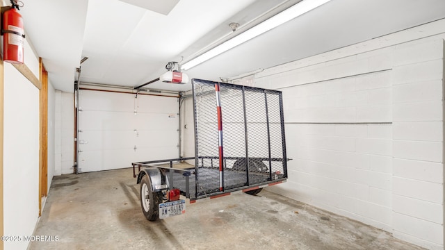 156 Baird Rd, Millstone, NJ 08535 - garage with concrete block wall and a garage door opener