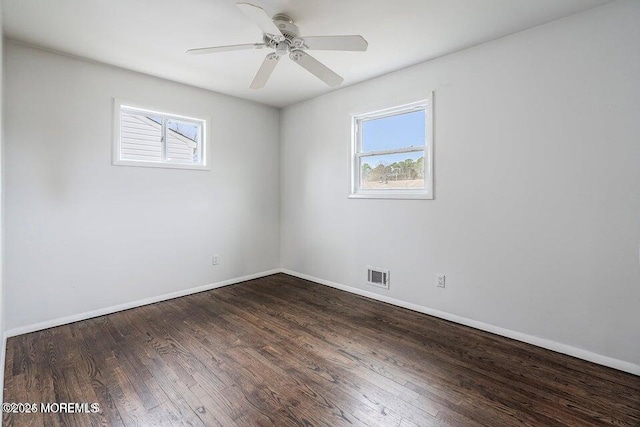unfurnished room with visible vents, baseboards, ceiling fan, and wood finished floors