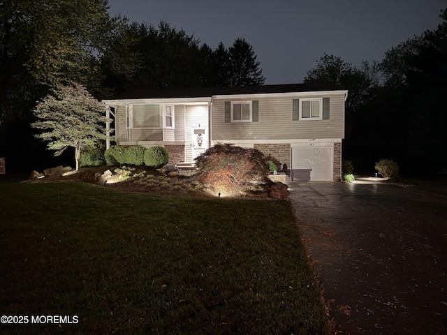 83 Campbell Ct, Freehold, NJ 07728 - split foyer home with driveway, a garage, a yard, and stone siding
