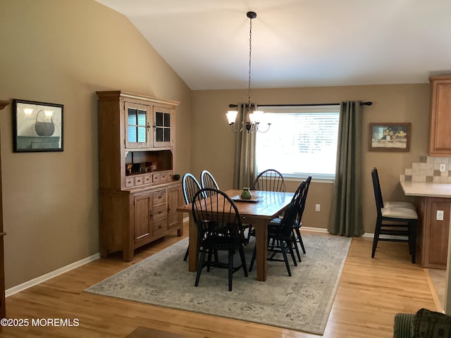 83 Campbell Ct, Freehold, NJ 07728 - dining room featuring light wood-type flooring, a chandelier, vaulted ceiling, and baseboards