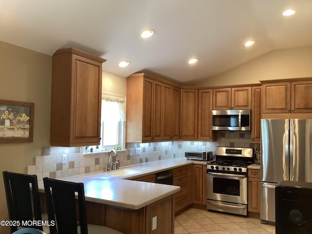 83 Campbell Ct, Freehold, NJ 07728 - kitchen featuring stainless steel appliances, a sink, a peninsula, light countertops, and brown cabinets