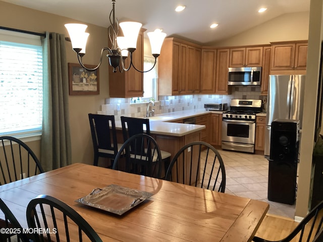 83 Campbell Ct, Freehold, NJ 07728 - kitchen with stainless steel appliances, vaulted ceiling, a sink, backsplash, and recessed lighting