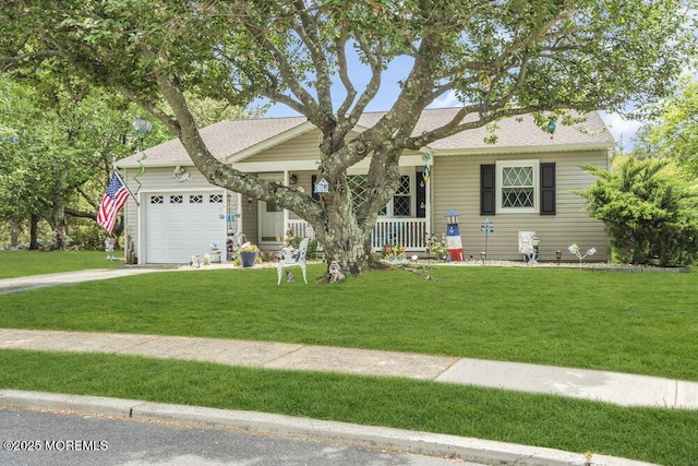 ranch-style home with covered porch, a front yard, roof with shingles, an attached garage, and driveway