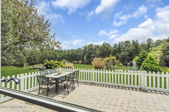 view of patio / terrace featuring fence and outdoor dining area