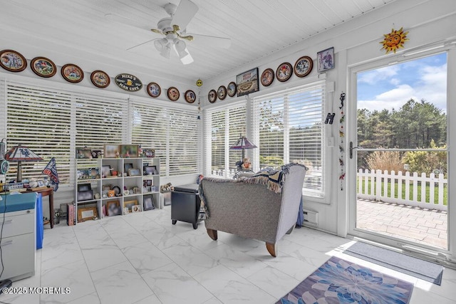 sunroom featuring marble finish floor