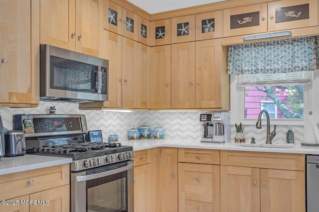 kitchen featuring a sink, light brown cabinets, and stainless steel appliances