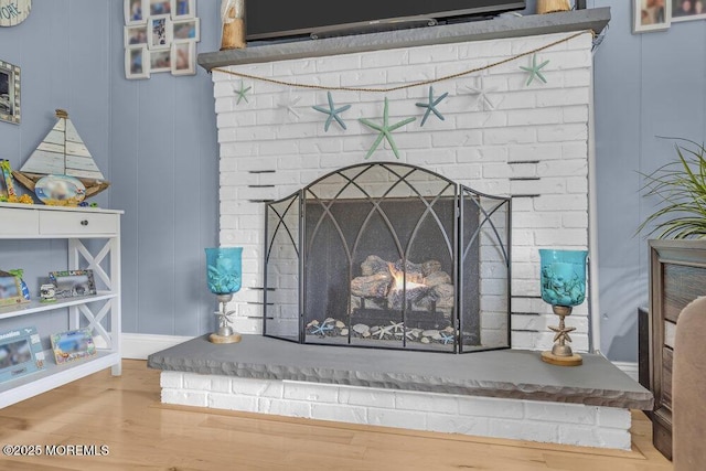 interior details with wood finished floors and a fireplace