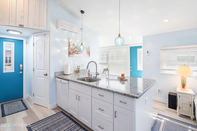 28 E Marlin Way, Lavallette, NJ 08735 - kitchen featuring a peninsula, a wall mounted air conditioner, a sink, light wood finished floors, and dishwasher