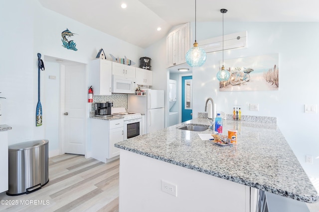 28 E Marlin Way, Lavallette, NJ 08735 - kitchen with a peninsula, white appliances, white cabinetry, a sink, and light wood-style flooring