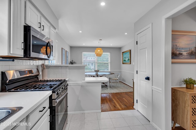 kitchen featuring stainless steel appliances, white cabinetry, light tile patterned floors, light countertops, and recessed lighting