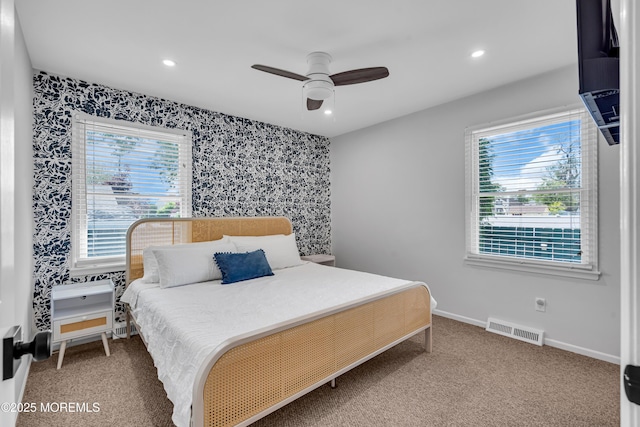 carpeted bedroom with wallpapered walls, multiple windows, recessed lighting, baseboards, and ceiling fan