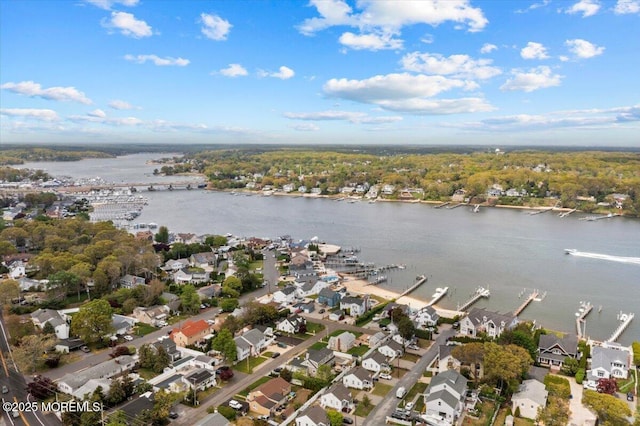 drone / aerial view with a water view and a residential view