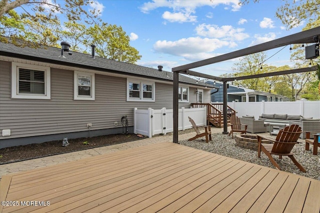 deck featuring an outdoor living space with a fire pit and fence