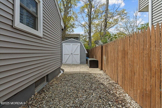 view of property exterior with an outbuilding, a storage shed, and fence