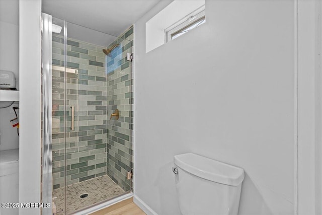 full bathroom featuring toilet and a shower stall