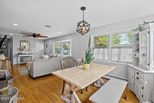 dining room with visible vents, recessed lighting, a baseboard radiator, light wood-style flooring, and a ceiling fan