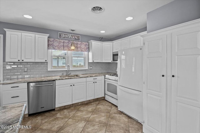 kitchen featuring visible vents, white cabinets, appliances with stainless steel finishes, and a sink