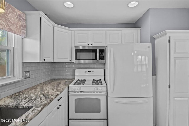 kitchen featuring recessed lighting, white appliances, light stone counters, decorative backsplash, and white cabinets