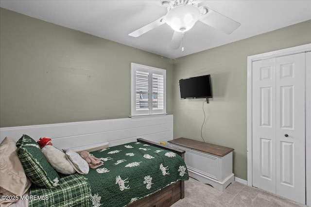 bedroom with a closet, ceiling fan, and carpet floors
