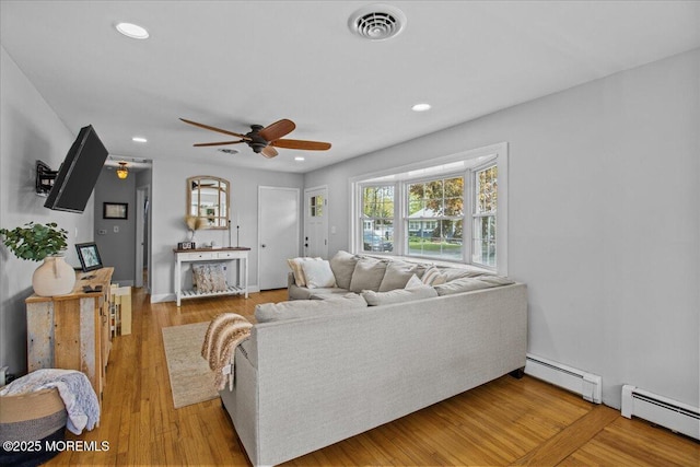 living room with visible vents, baseboard heating, ceiling fan, and recessed lighting