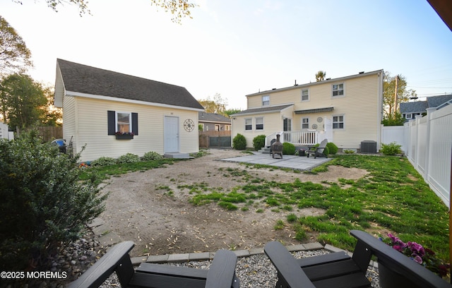 back of property featuring central air condition unit, a patio area, and a fenced backyard