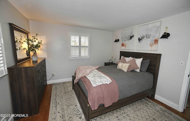 bedroom featuring light wood finished floors and baseboards