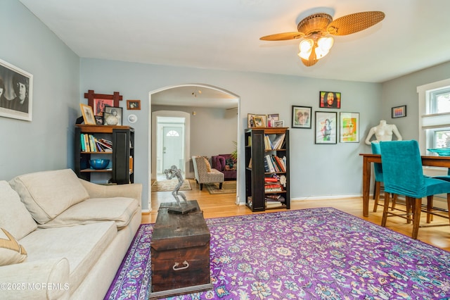 1118 Jeffrey St, Asbury Park, NJ 07712 - living area featuring arched walkways, wood finished floors, a ceiling fan, and baseboards