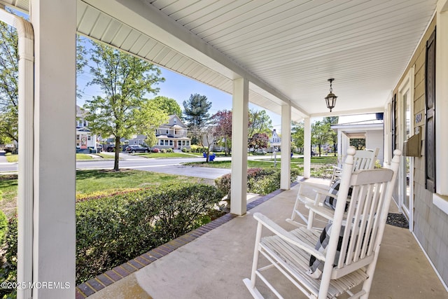 view of patio featuring covered porch and a residential view