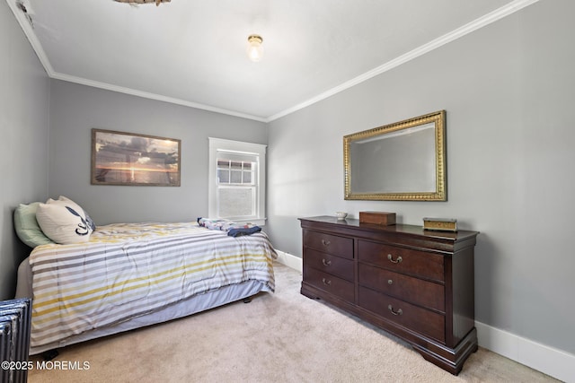 bedroom with crown molding, baseboards, and carpet floors