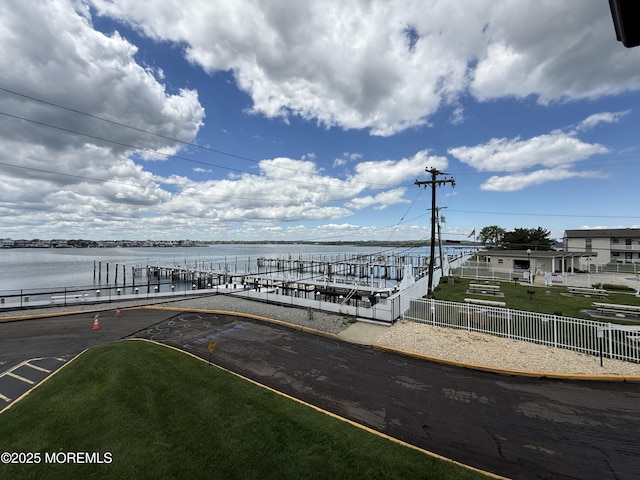 dock featuring a water view and fence