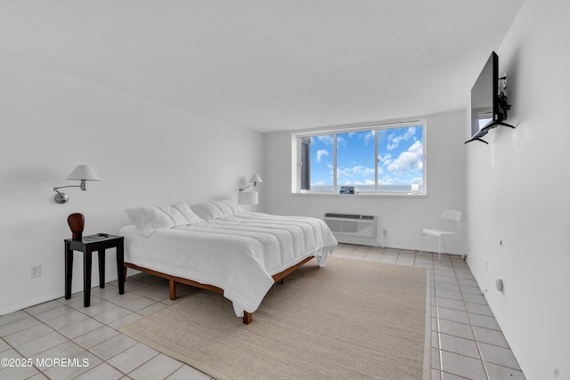 55 Ocean Ave Unit 3L, Monmouth Beach, NJ 07750 - bedroom featuring a wall mounted air conditioner, light tile patterned floors, and baseboards